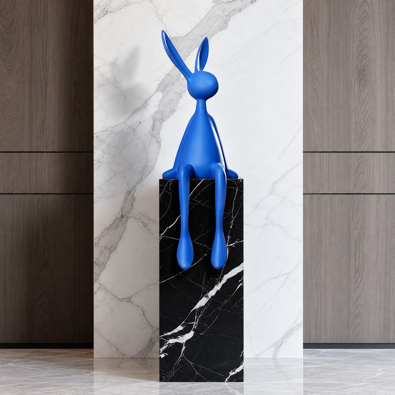 Rabbit resin sculpture displayed on a sideboard or display cabinet as an art accent