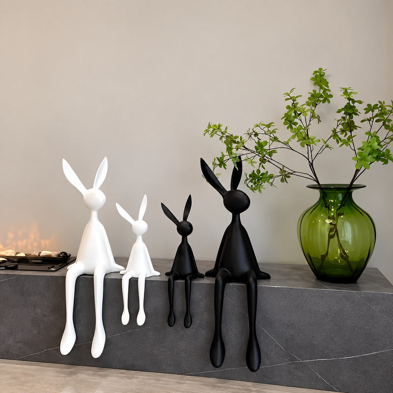 Rabbit resin sculpture on a media console adding a playful modern touch