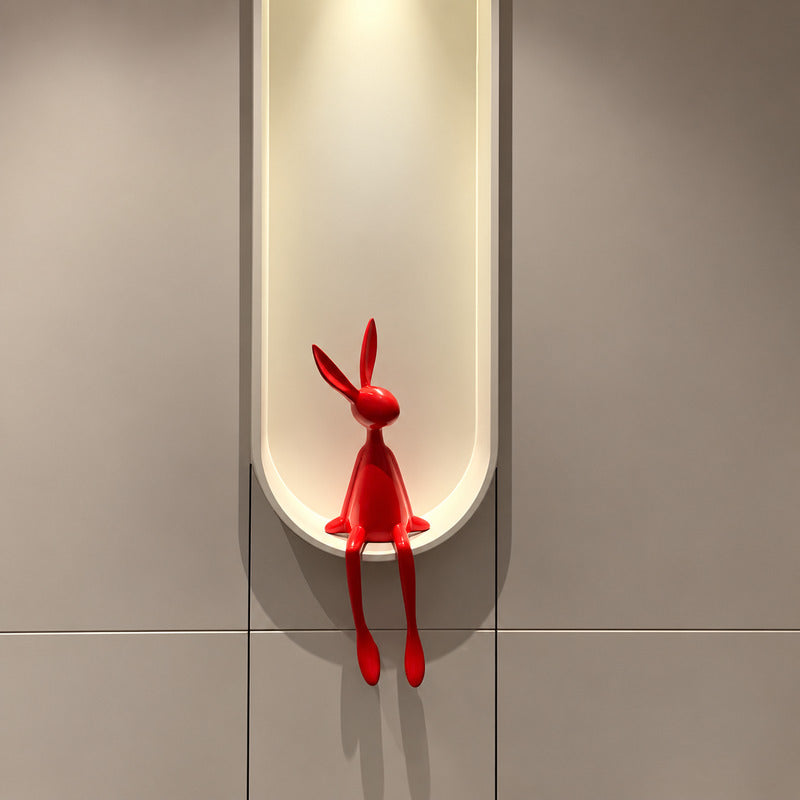 Rabbit resin sculpture displayed on a sideboard or display cabinet as an art accent