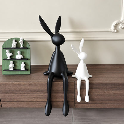 Rabbit resin sculpture on a media console adding a playful modern touch