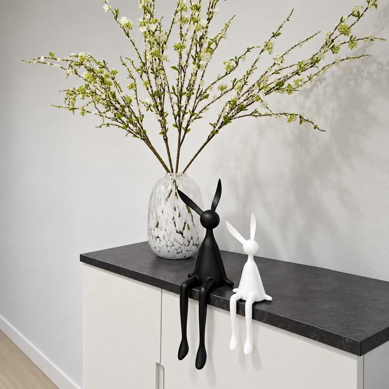 Rabbit resin sculpture displayed on a sideboard or display cabinet as an art accent