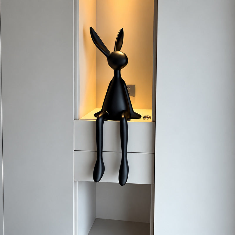 Rabbit resin sculpture on a media console adding a playful modern touch