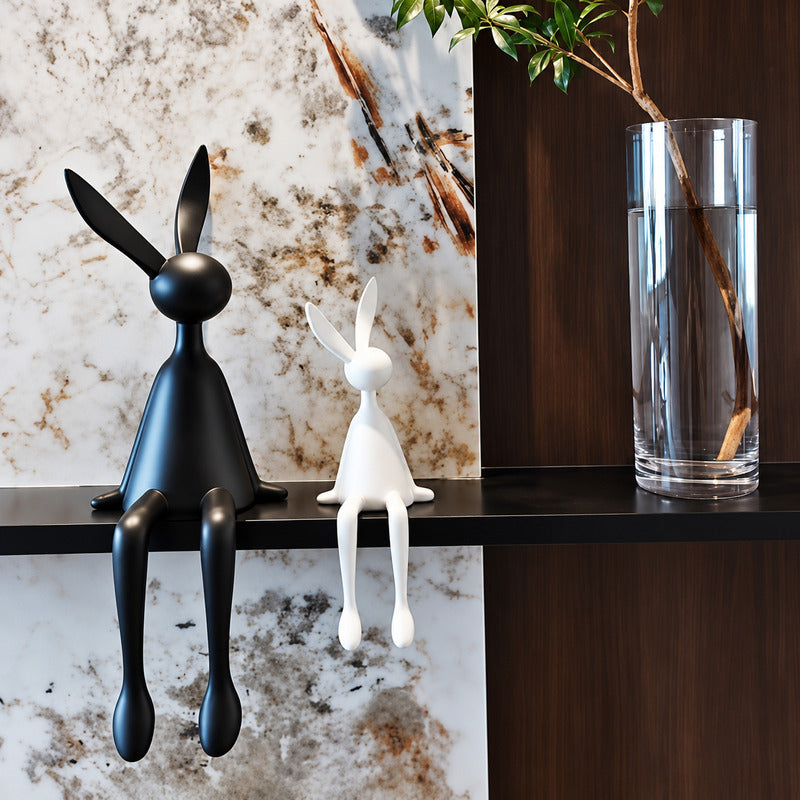 Rabbit resin sculpture displayed on a sideboard or display cabinet as an art accent