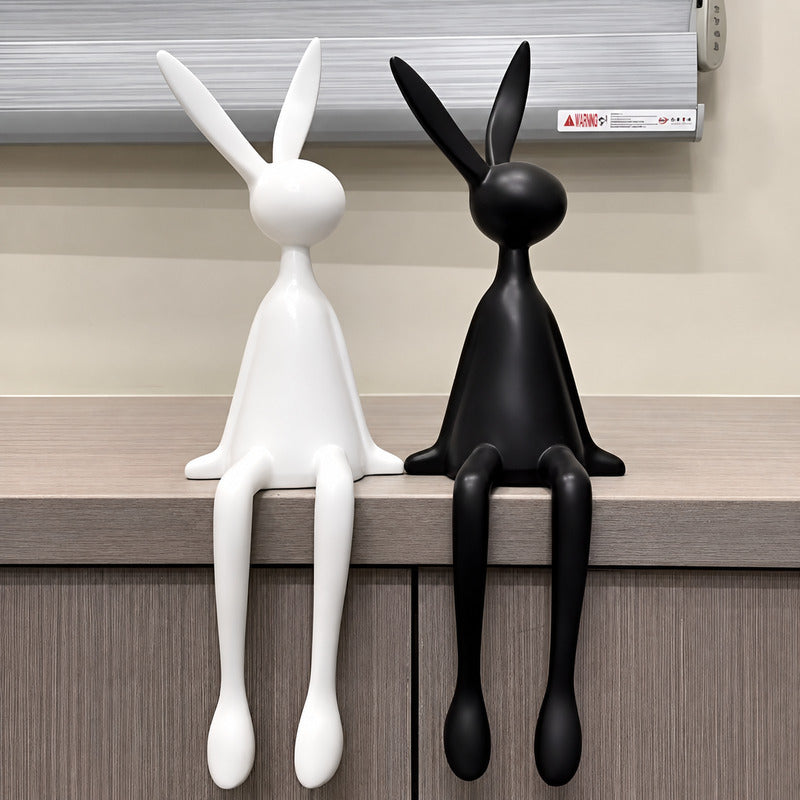 Rabbit resin sculpture on a media console adding a playful modern touch