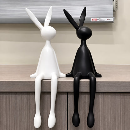 Rabbit resin sculpture on a media console adding a playful modern touch