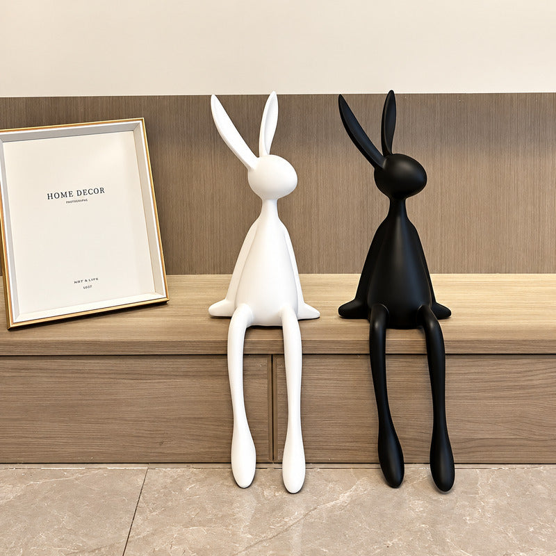Rabbit resin sculpture on a media console adding a playful modern touch