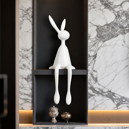 Rabbit resin sculpture displayed on a sideboard or display cabinet as an art accent