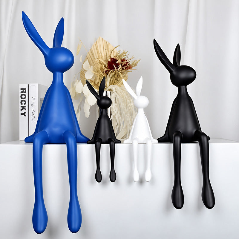Rabbit resin sculpture styled as a decorative accent on a modern living room bookshelf