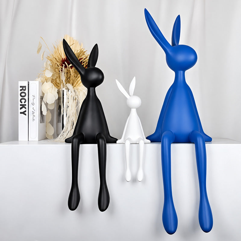 Rabbit resin sculpture styled as a decorative accent on a modern living room bookshelf