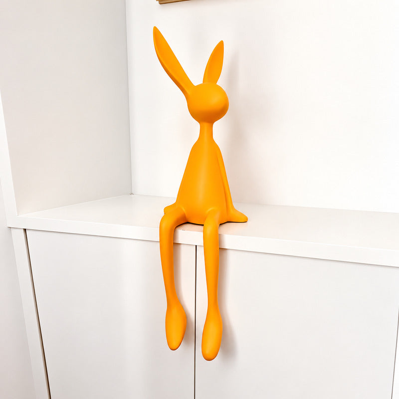 Small 19.7-inch yellow rabbit resin sculpture brightening a bookshelf