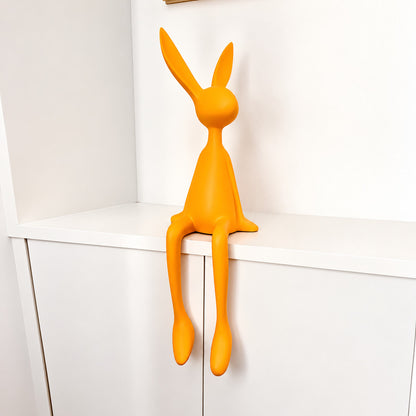 Small 19.7-inch yellow rabbit resin sculpture brightening a bookshelf