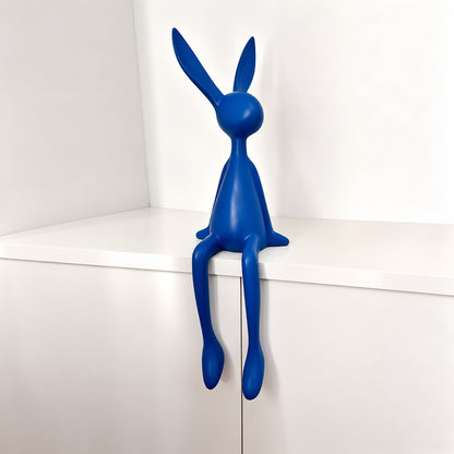 Small 19.7-inch purple rabbit resin sculpture as a playful accent on a console