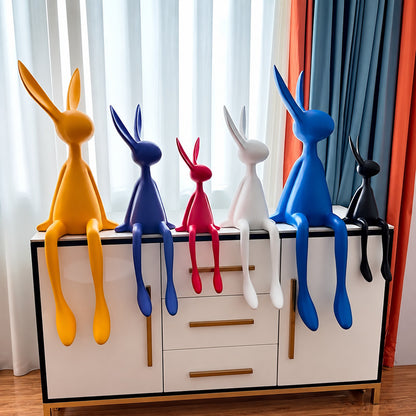 Rabbit resin sculpture on a media console adding a playful modern touch