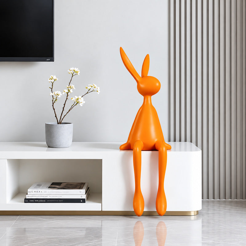 Rabbit resin sculpture on a media console adding a playful modern touch