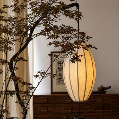 Ramo floor lamp illuminated warm ambient glow through oval fabric shade evening cozy intimate sculptural tree sophisticated Japandi wabi-sabi detail close up mood