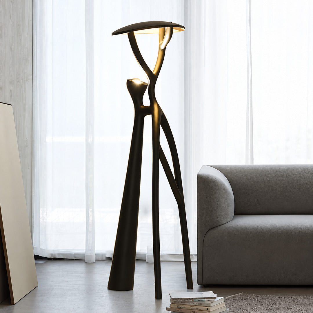 Ramo tree sculpture floor lamp standing beside a sofa as a dramatic centerpiece in a living room