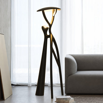 Ramo tree sculpture floor lamp standing beside a sofa as a dramatic centerpiece in a living room