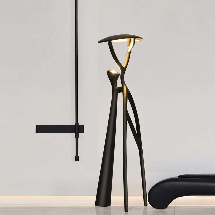 Ramo tree sculpture floor lamp filling a living room corner with a warm sculptural glow