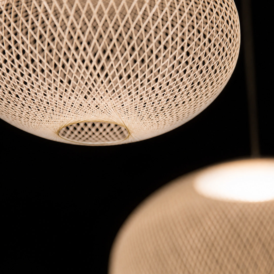 Detail of the soft shadow play cast through the iron mesh of the Reticella pendant light