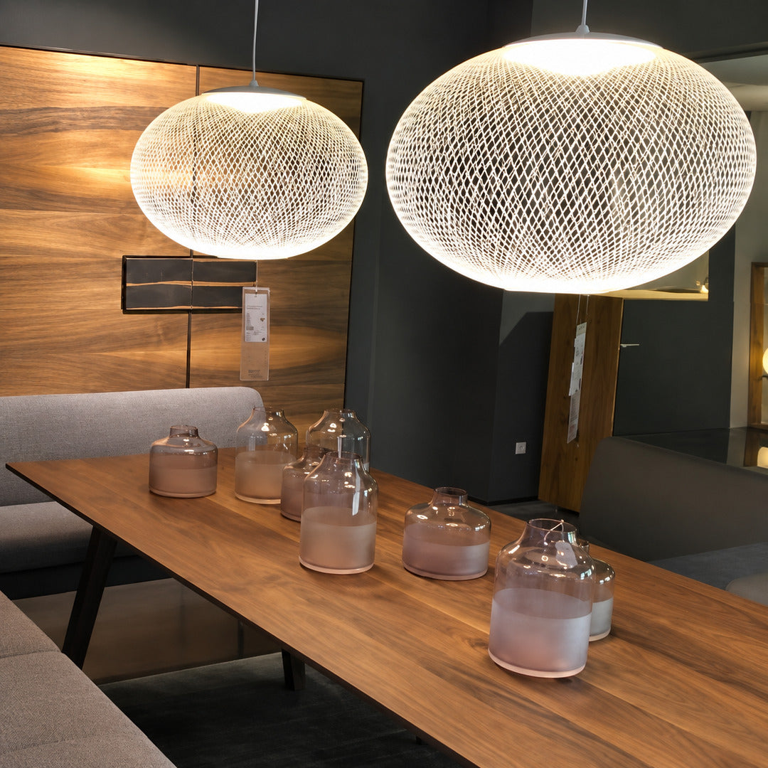 Reticella mesh pendant lights suspended over a modern kitchen island