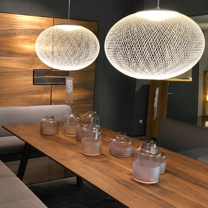 Reticella mesh pendant lights suspended over a modern kitchen island