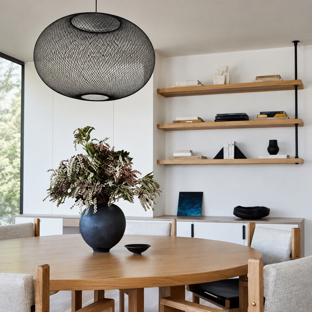 Reticella mesh pendant light casting a warm glow over a dining table