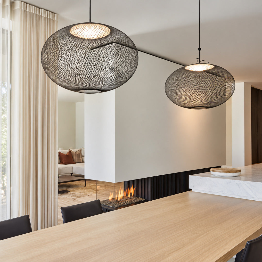 Reticella mesh pendant lights suspended over a modern kitchen island