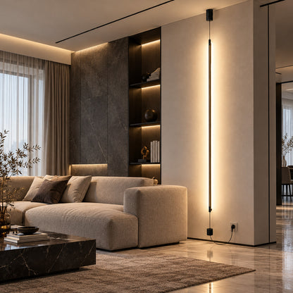 Riga floor to ceiling lamp drawing a warm vertical line behind a low sectional sofa