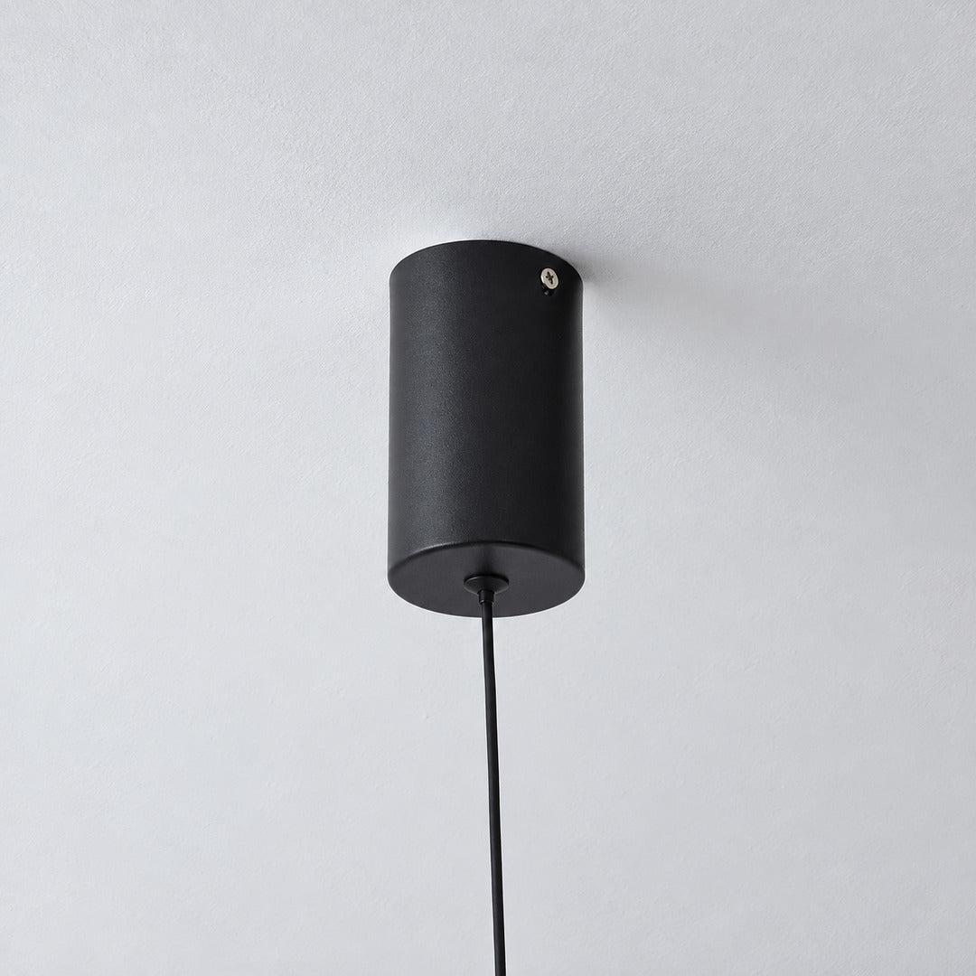 Slim ceiling mount holding the top of the Riga floor to ceiling lamp cable