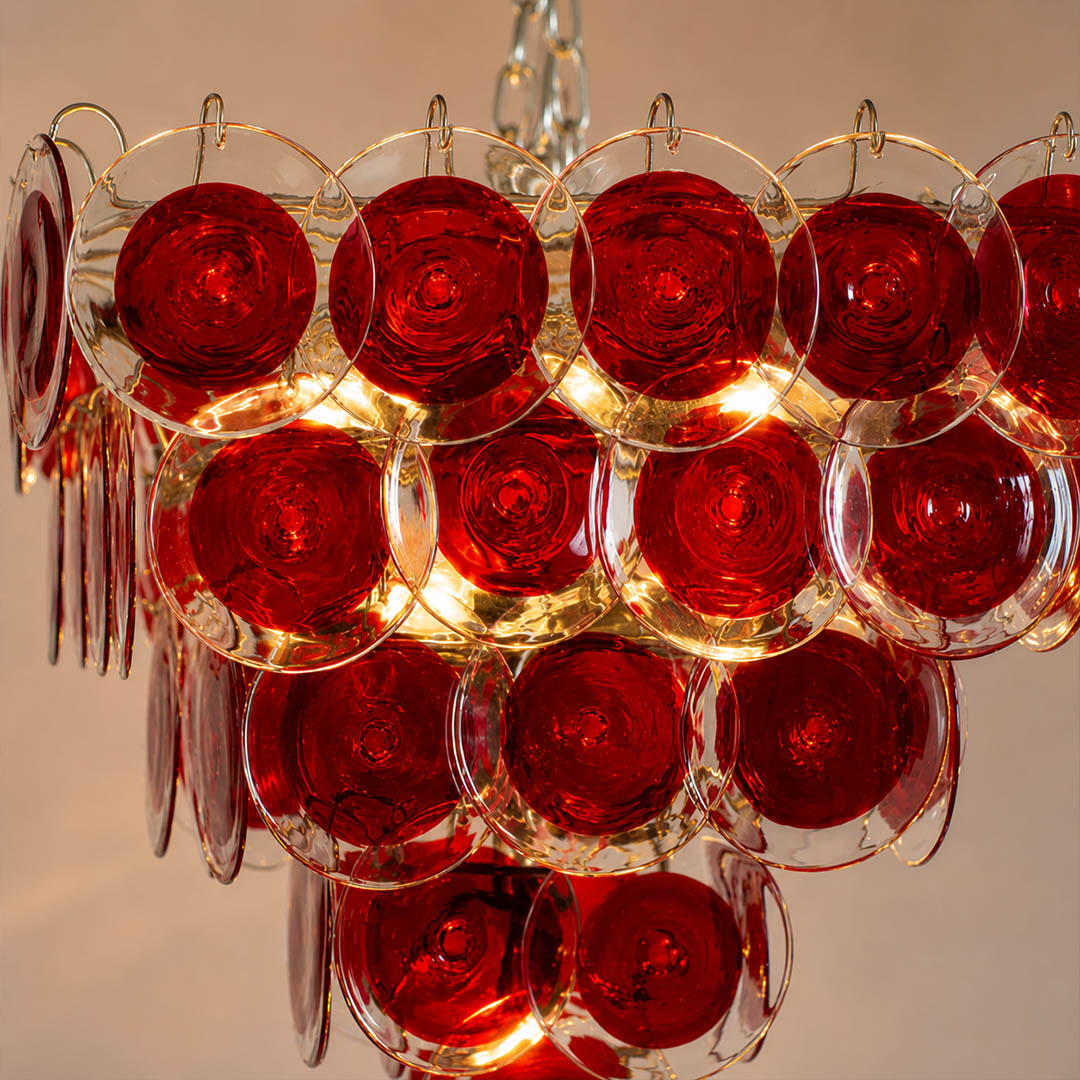 Ruby red Murano glass disc translucent hand blown Italian craftsmanship detail close up unique premium exclusive quality artisan French vintage