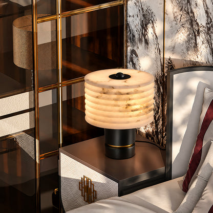 Pair of Sasso table lamps on nightstands flanking a bed