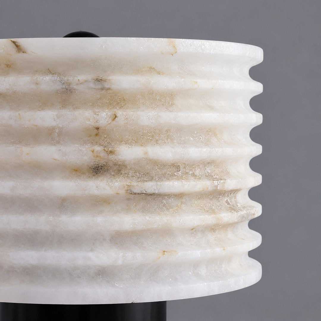 Close-up of natural veining glowing through the hand-cut alabaster shade of the Sasso lamp