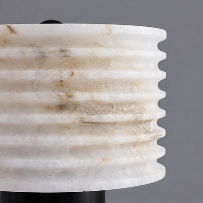 Close-up of natural veining glowing through the hand-cut alabaster shade of the Sasso lamp