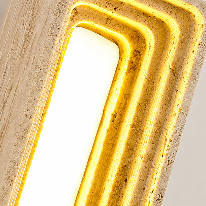 Sasso travertine wall sconce illuminated warm light glowing stone veining amber detail close up