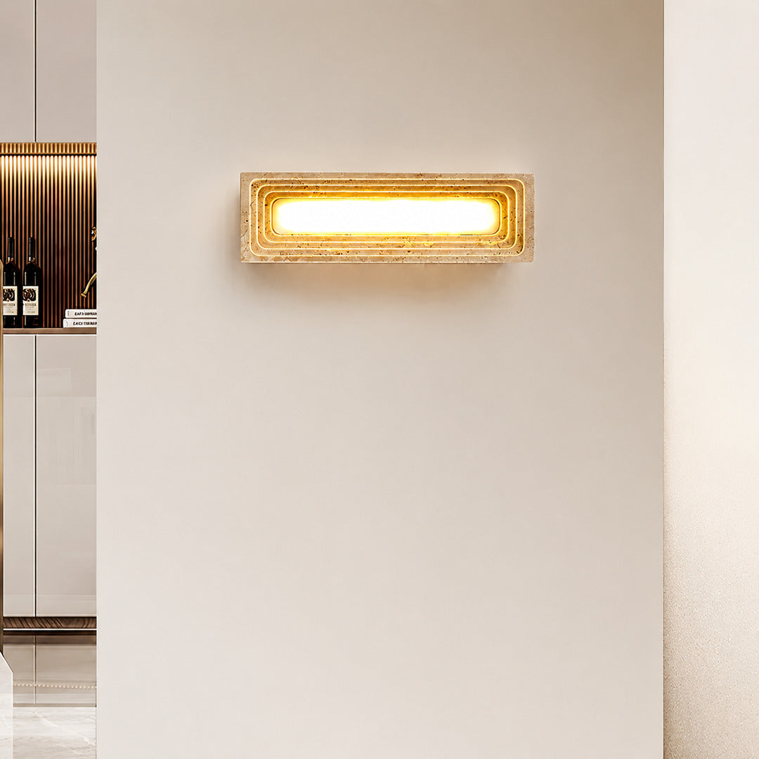 Sasso travertine wall sconce hallway corridor accent warm glow travertine stone column minimalist American home lifestyle interior styled