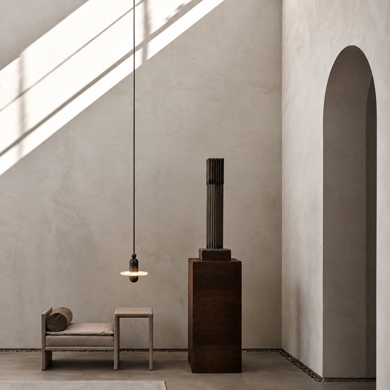 Double-disc Saturno alabaster pendant welcoming guests in a double-height entryway