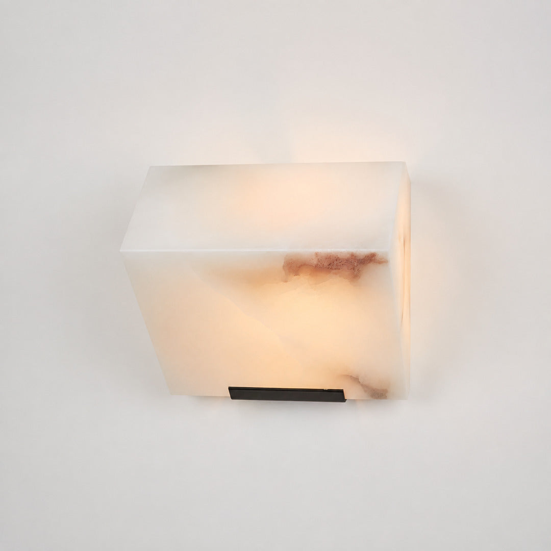 Single-panel Scala alabaster wall sconce as a compact warm accent beside a bed