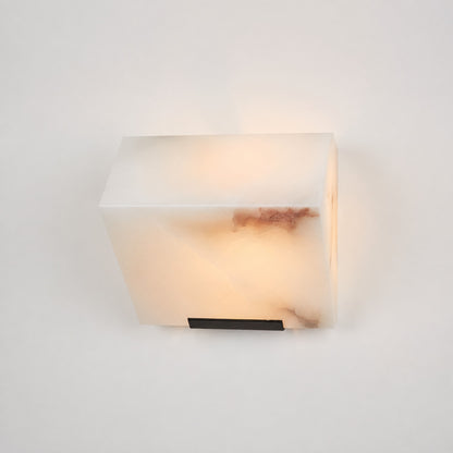 Single-panel Scala alabaster wall sconce as a compact warm accent beside a bed
