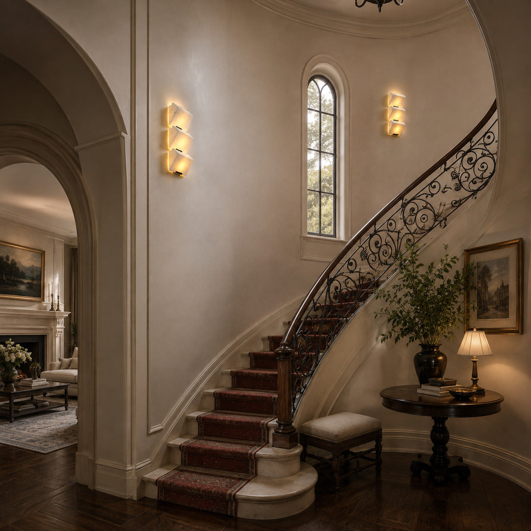Scala alabaster wall sconce lighting a staircase wall with a soft stepped natural-stone glow