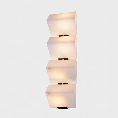 Three-panel Scala alabaster wall sconce as a sculptural stepped accent on a staircase wall