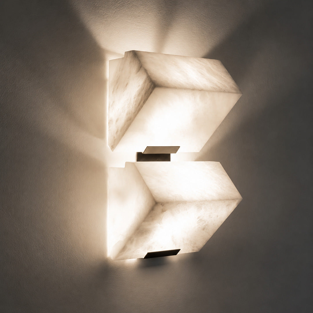 Warm integrated LED glow diffusing evenly through the alabaster panels of the Scala wall sconce