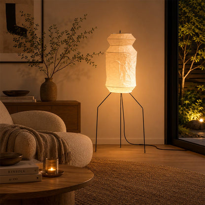 Tall sculptural Washi Paper UF3-L6 Floor Lamp placed in a modern luxury lounge facing a garden window by Stuber Lighting.
