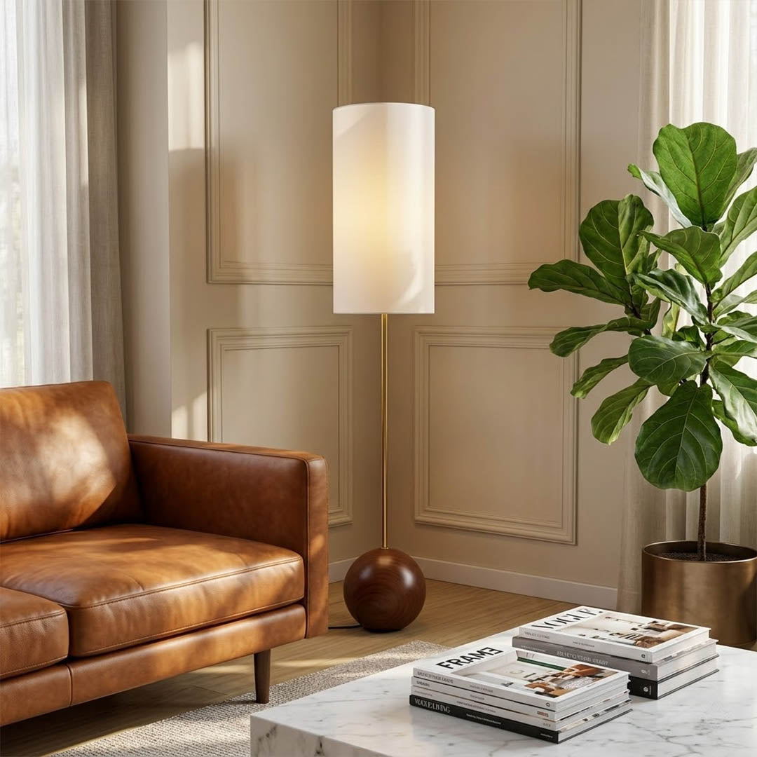 Senja wood floor lamp beside reading chair living room warm glow scandinavian interior
