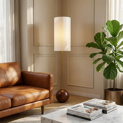 Senja wood floor lamp beside reading chair living room warm glow scandinavian interior