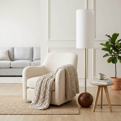 Senja wood floor lamp beside reading chair living room warm glow scandinavian interior