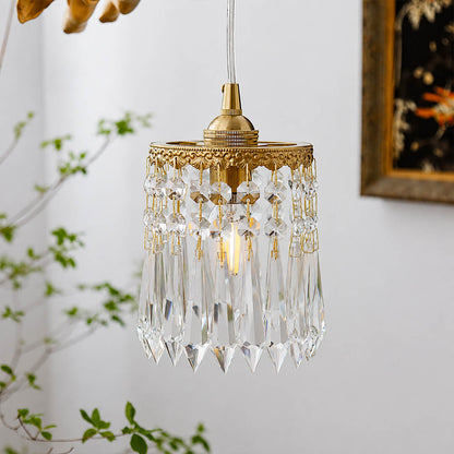 Serafino cascade pendant illuminated sparkling crystal light refraction brass angel evening magical glamorous glow detail close up mood