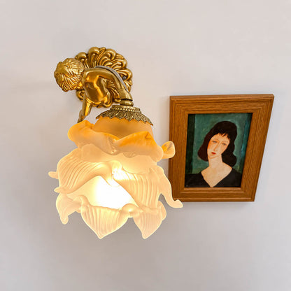 Serafino wall sconce brass finish angel living room feature wall beside framed portrait vintage baroque warm American home lifestyle interior
