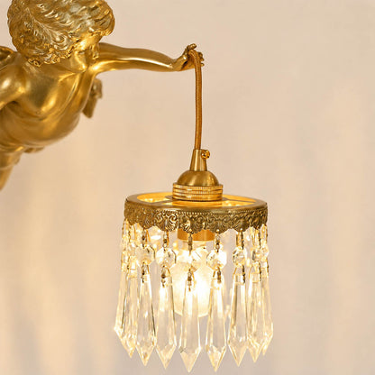 Serafino wall sconce brass finish angel cherub figure holding glass flower shade sculpted detail close up craftsmanship