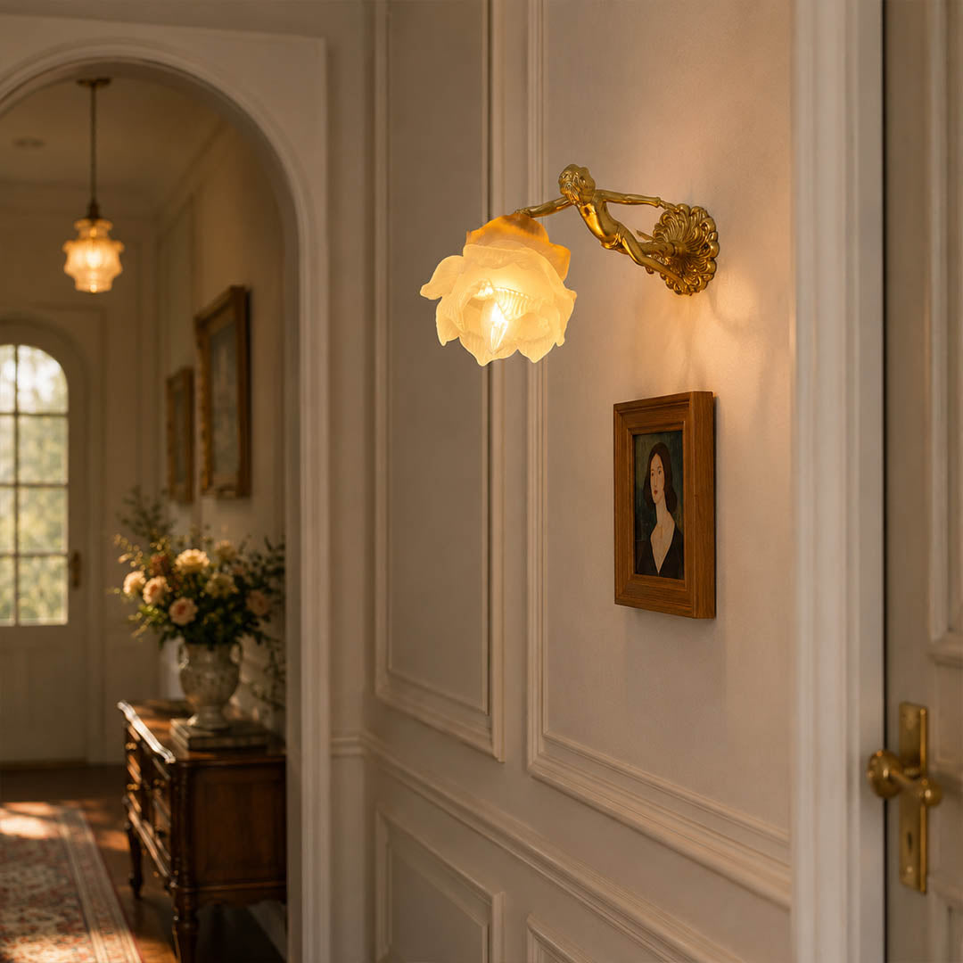 Serafino wall sconce brass finish angel living room feature wall beside framed portrait vintage baroque warm American home lifestyle interior