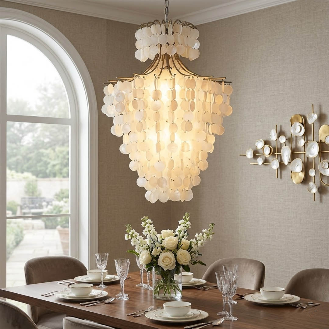 Serena Gold double tier Capiz shell chandelier grand dining room large table 10 seater Coastal mansion warm pearl glow lifestyle interior
